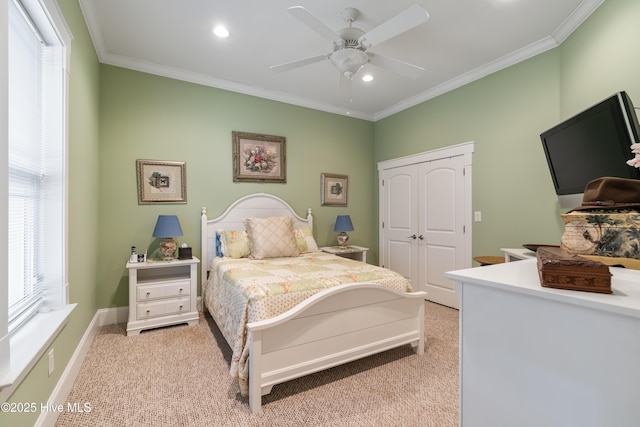 bedroom featuring light colored carpet, ceiling fan, a closet, and multiple windows