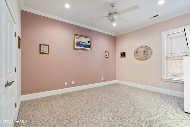 unfurnished room featuring ceiling fan, light carpet, and crown molding