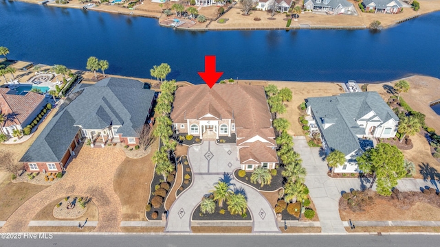 birds eye view of property with a water view