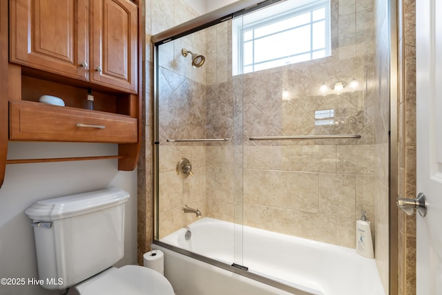 bathroom featuring toilet and enclosed tub / shower combo