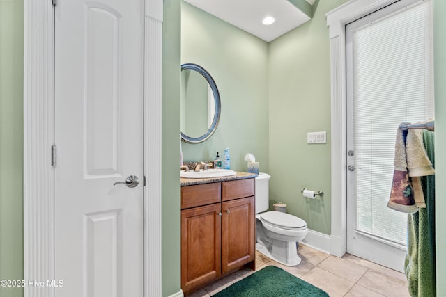 bathroom with toilet, tile patterned flooring, and vanity