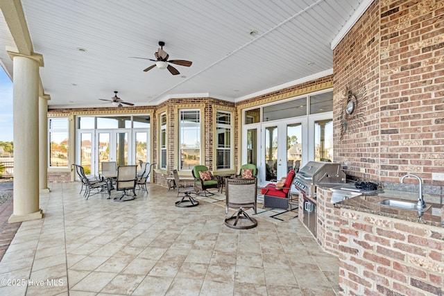 view of patio with sink, french doors, a grill, and exterior kitchen