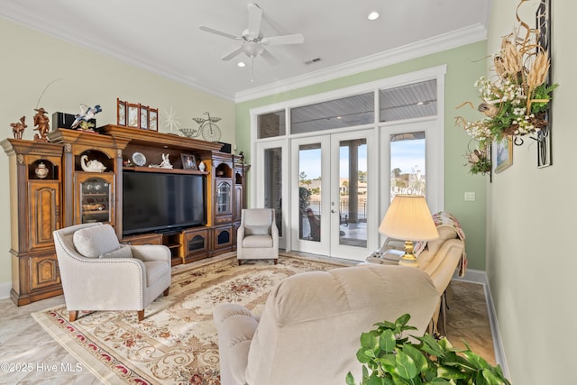 living room with ornamental molding, ceiling fan, and french doors