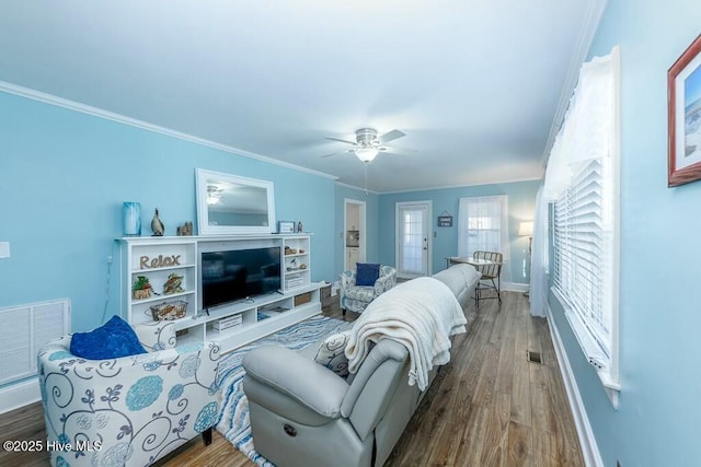 living room featuring hardwood / wood-style flooring, ceiling fan, and crown molding