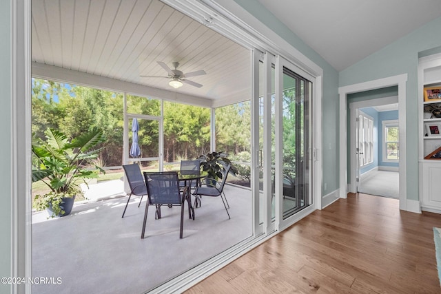 unfurnished sunroom featuring ceiling fan and lofted ceiling