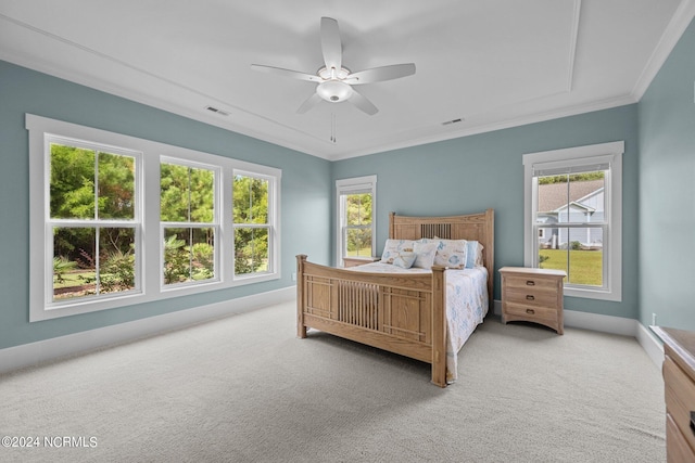 carpeted bedroom featuring ceiling fan and ornamental molding