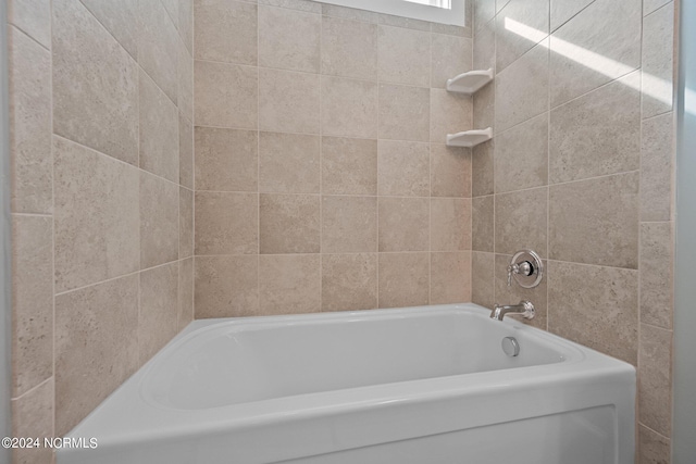 bathroom with a tub to relax in