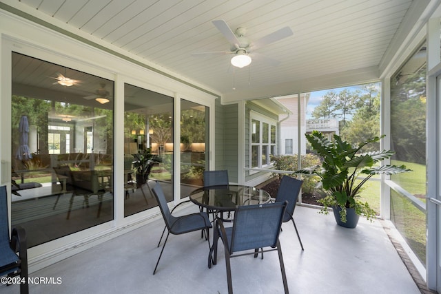 sunroom / solarium featuring ceiling fan