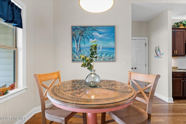 dining space featuring dark hardwood / wood-style flooring