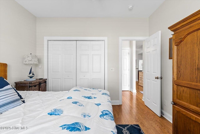 bedroom featuring light wood-type flooring and a closet