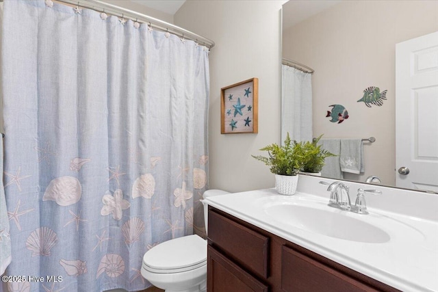 bathroom featuring toilet and vanity