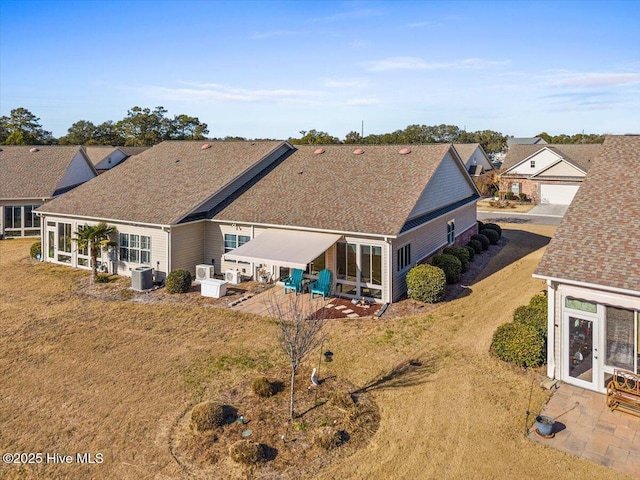 back of property featuring central AC unit, a yard, and a patio