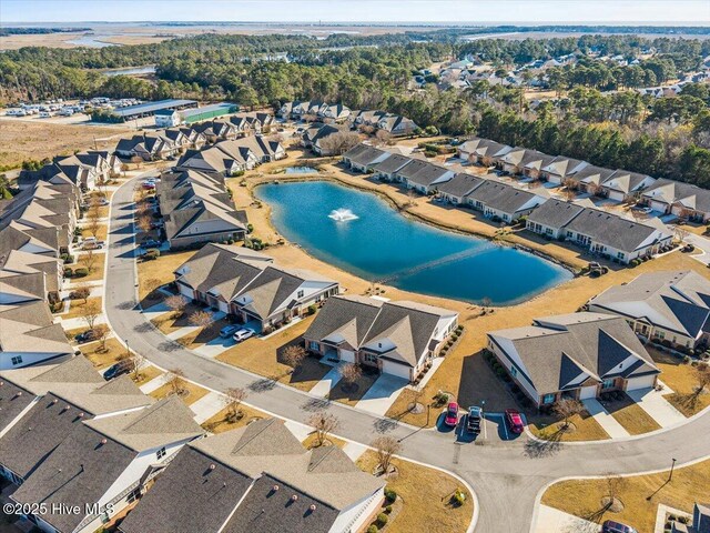 birds eye view of property with a water view and a residential view