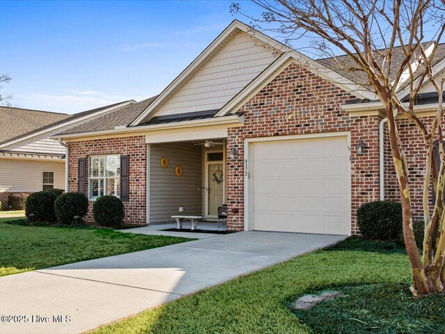 view of front of home with a front yard, a garage, brick siding, concrete driveway, and a shingled roof