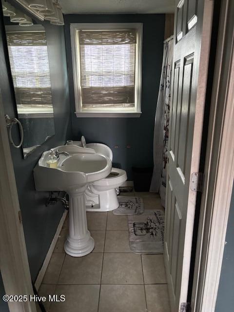 bathroom with tile patterned floors and toilet