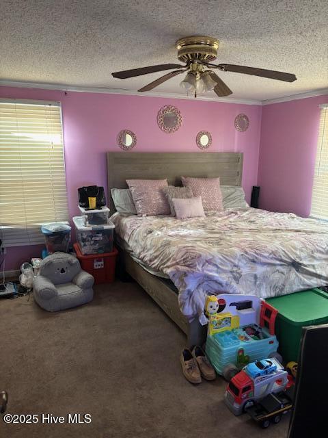 carpeted bedroom featuring ceiling fan, a textured ceiling, and ornamental molding