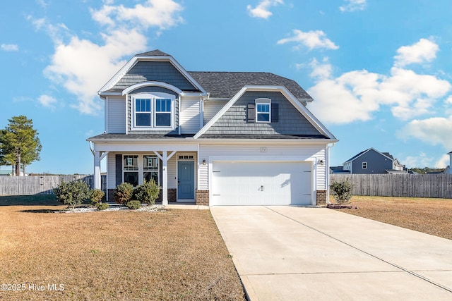 craftsman inspired home with a garage and a front lawn