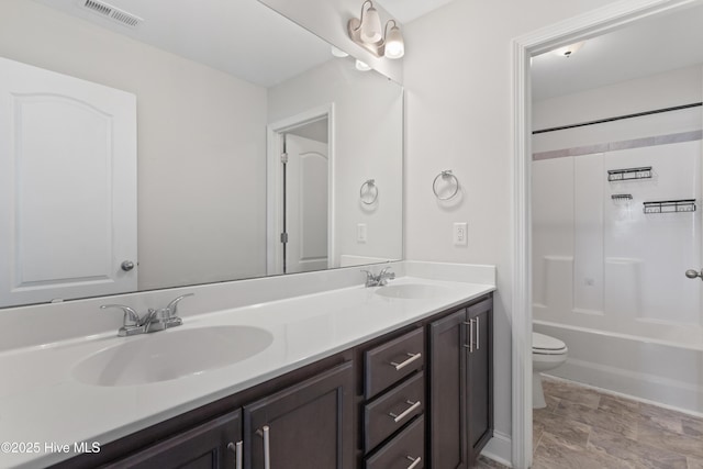 full bathroom with bathing tub / shower combination, vanity, and toilet