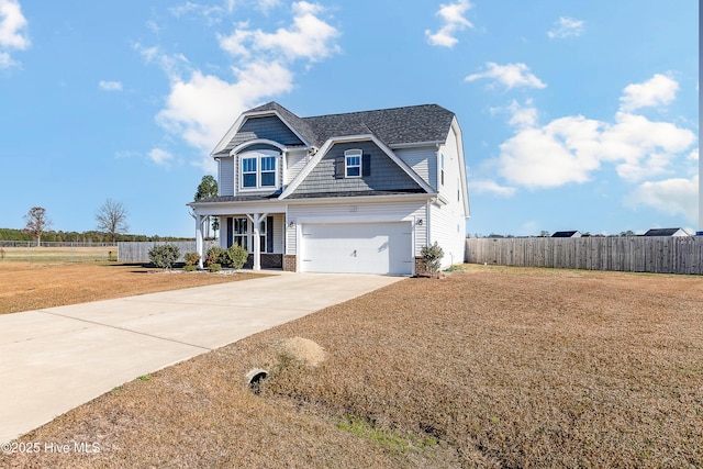 view of front of home featuring covered porch and a garage