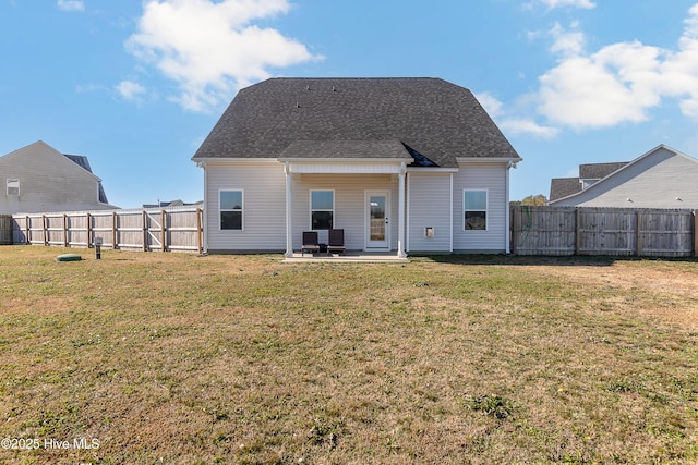 back of property with a lawn and a patio area