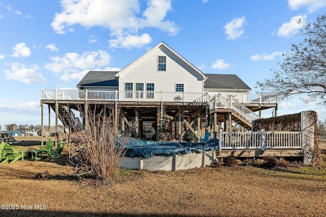 rear view of house with a pool side deck