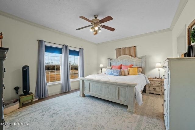 bedroom with ceiling fan and ornamental molding