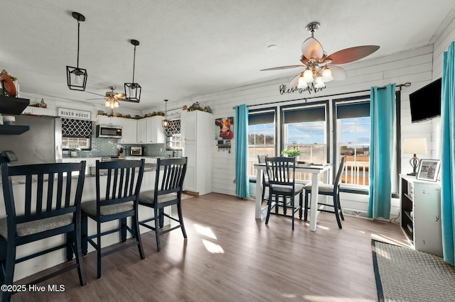 kitchen featuring white cabinetry, hardwood / wood-style floors, pendant lighting, and ceiling fan