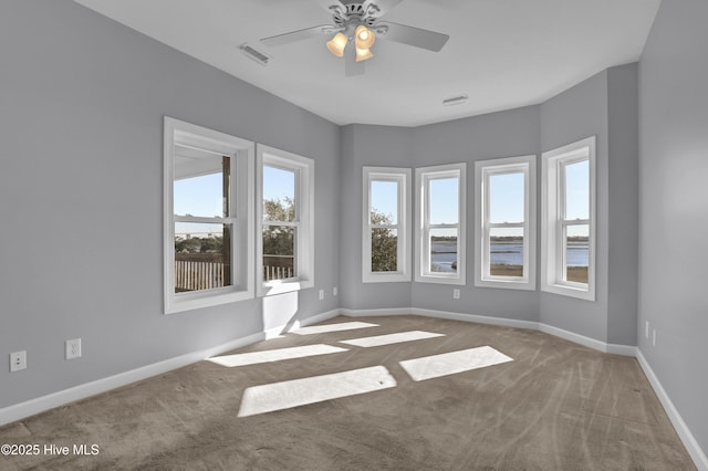 empty room with carpet and ceiling fan