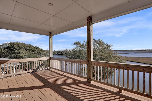 wooden deck featuring a water view