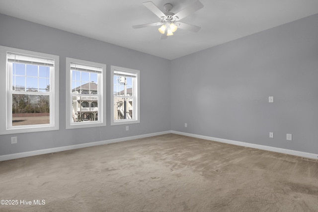 carpeted empty room featuring ceiling fan