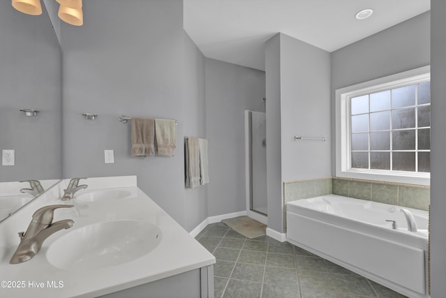 bathroom featuring vanity and shower with separate bathtub