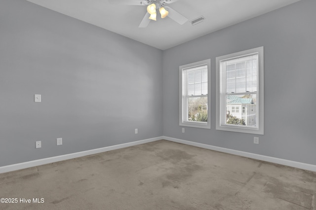 empty room featuring light carpet and ceiling fan