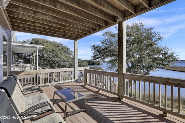 wooden terrace featuring a water view