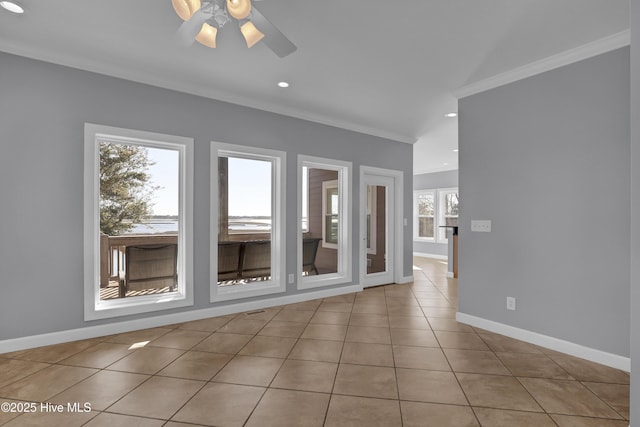 tiled spare room with ceiling fan and crown molding