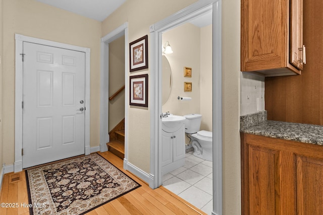 interior space featuring hardwood / wood-style floors, vanity, and toilet