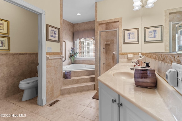 full bathroom featuring vanity, plus walk in shower, tile walls, tile patterned flooring, and toilet