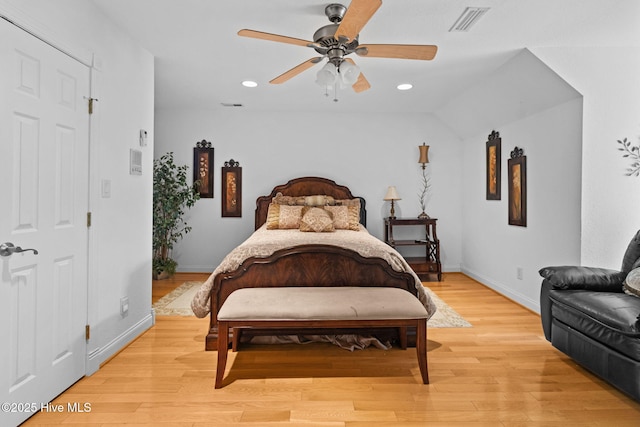 bedroom featuring ceiling fan, light wood-type flooring, and lofted ceiling