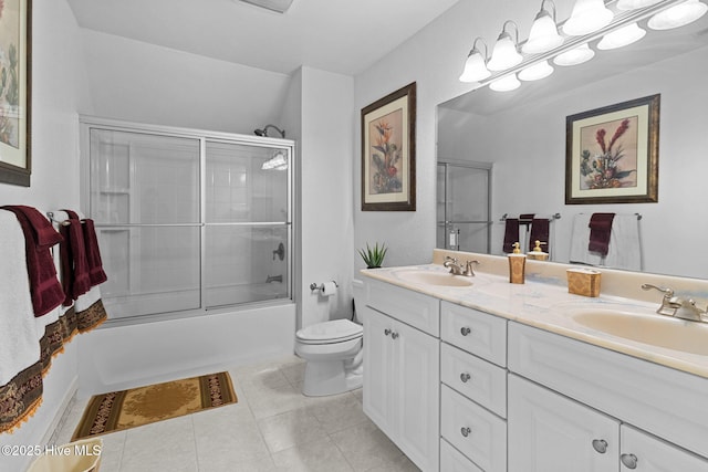 full bathroom featuring combined bath / shower with glass door, vanity, toilet, and tile patterned flooring