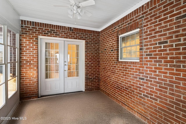 view of exterior entry with ceiling fan and french doors