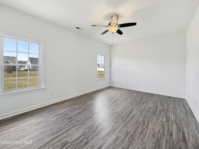 unfurnished room featuring ceiling fan and dark hardwood / wood-style flooring