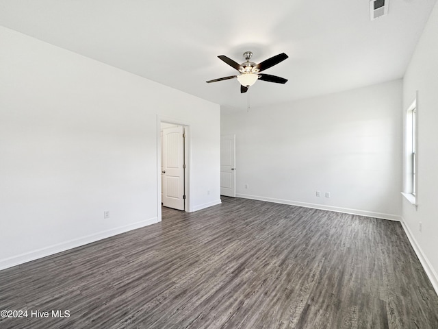 unfurnished room with ceiling fan and dark wood-type flooring