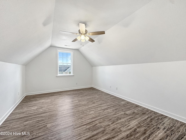 bonus room with ceiling fan, dark hardwood / wood-style flooring, and lofted ceiling