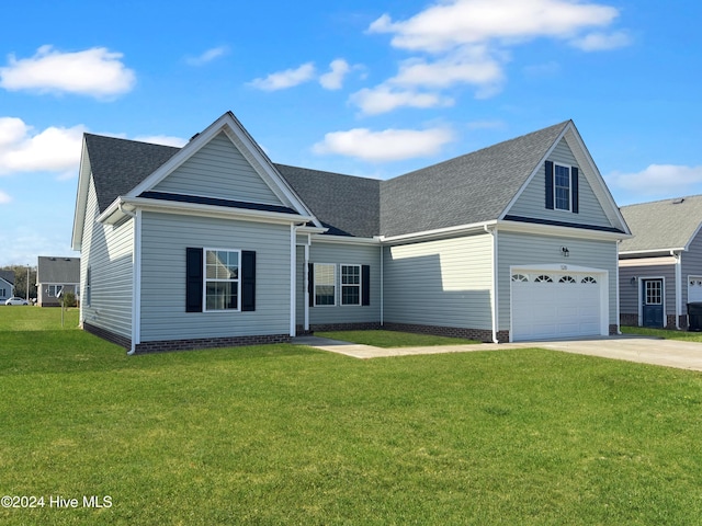 view of front facade with a front yard and a garage