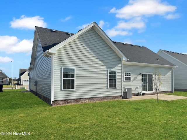 back of house featuring a lawn, a patio area, and central AC