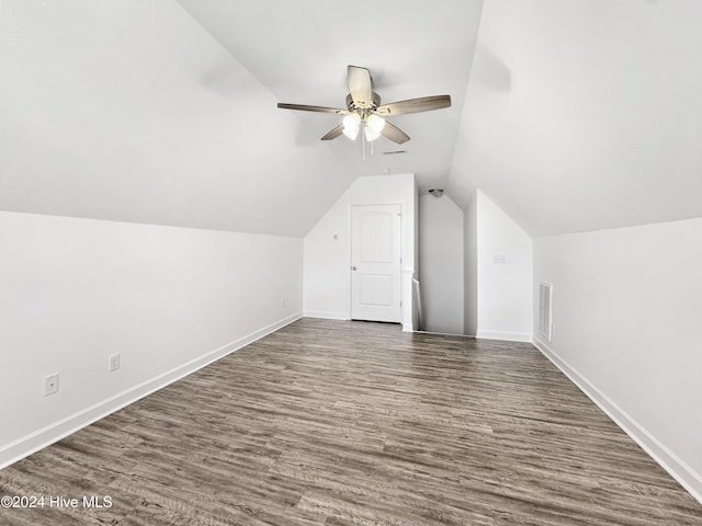 bonus room featuring ceiling fan, dark wood-type flooring, and vaulted ceiling