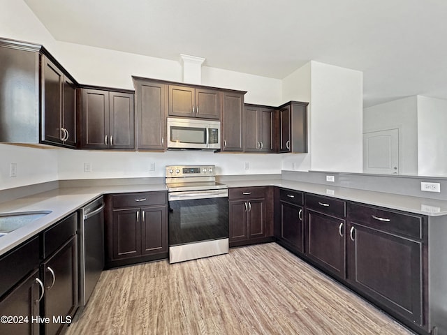 kitchen with light hardwood / wood-style floors, dark brown cabinetry, sink, and appliances with stainless steel finishes