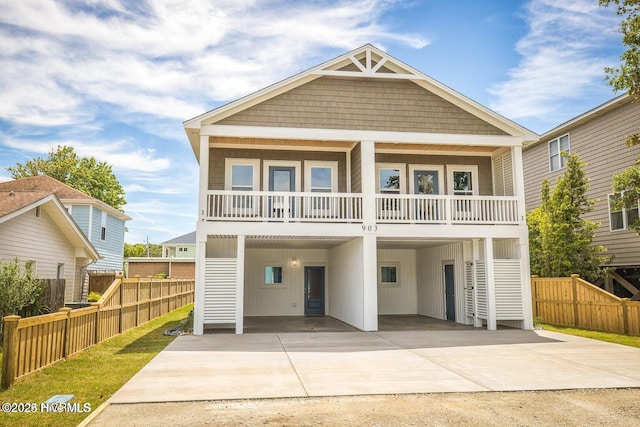 view of front facade with a balcony and a carport