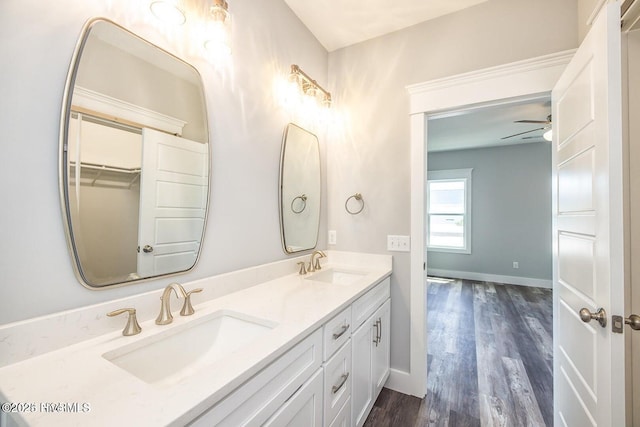 bathroom featuring hardwood / wood-style floors, vanity, and ceiling fan