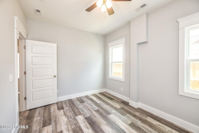 empty room featuring ceiling fan and hardwood / wood-style floors