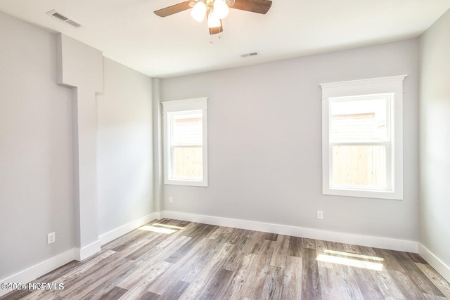 spare room featuring ceiling fan and light hardwood / wood-style floors